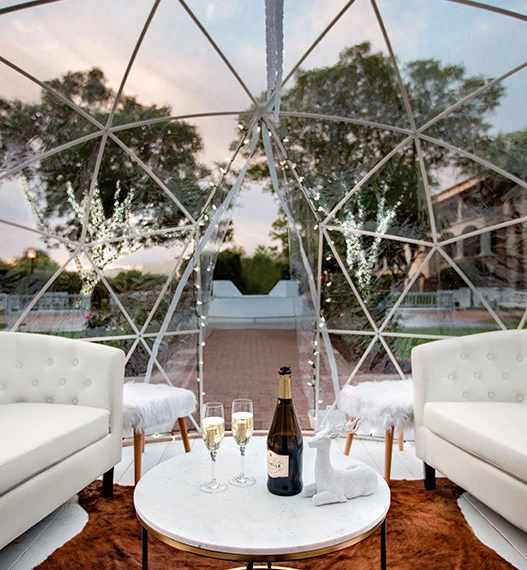 a table with wine glasses and bottles on it