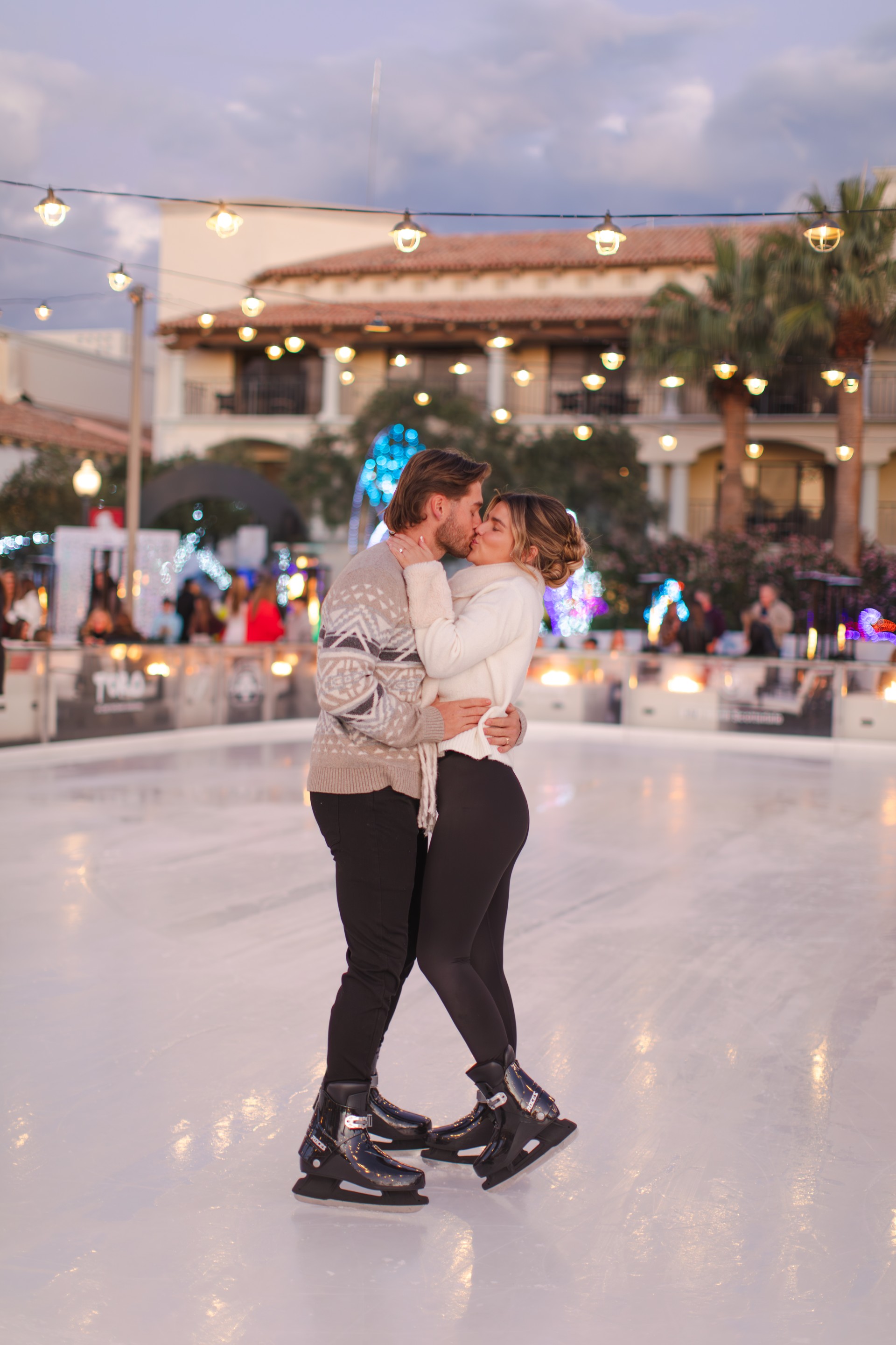 a man and woman kissing on ice