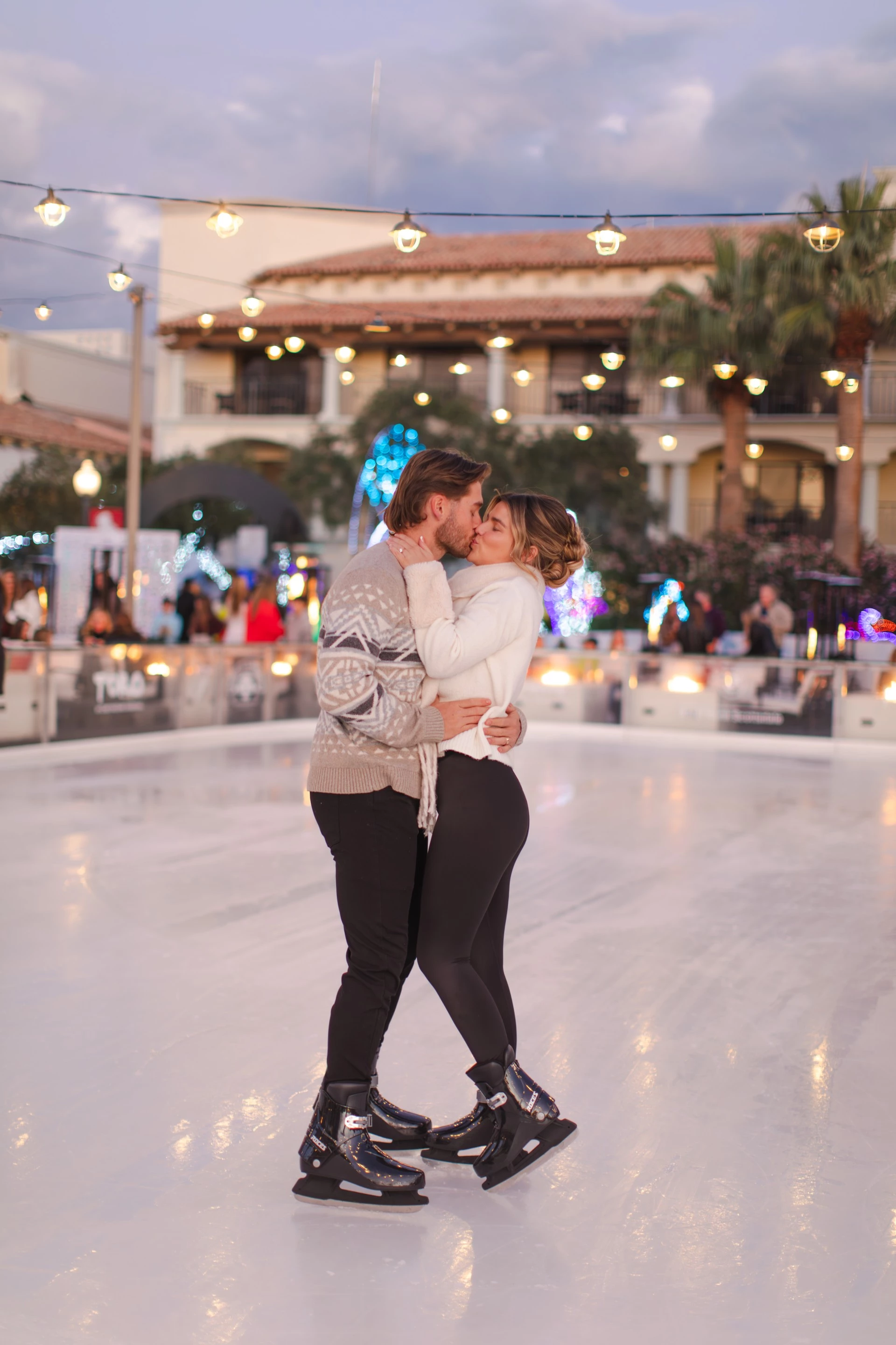 a man and woman kissing on ice