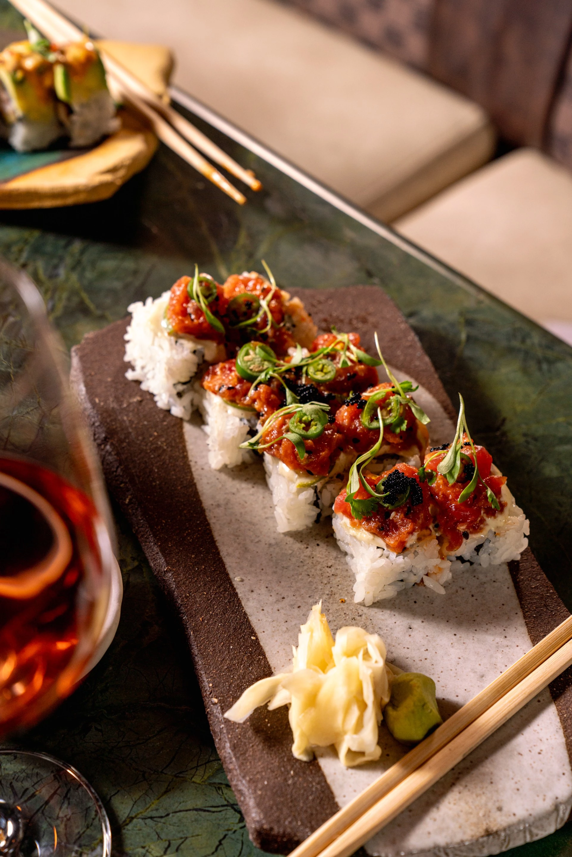 a plate of sushi with chopsticks