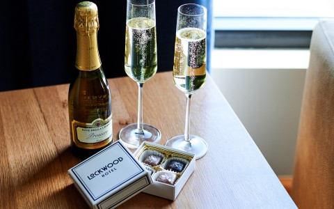 two glasses of champagne and a box of chocolates main