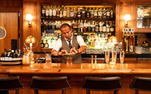a man standing at a bar main