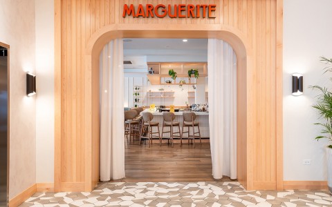 a restaurant with a wood arch and white curtains main