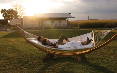 a man and woman lying in a hammock main