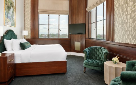 a room with a bed and a green chair main