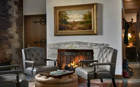 a room with a fireplace and chairs main