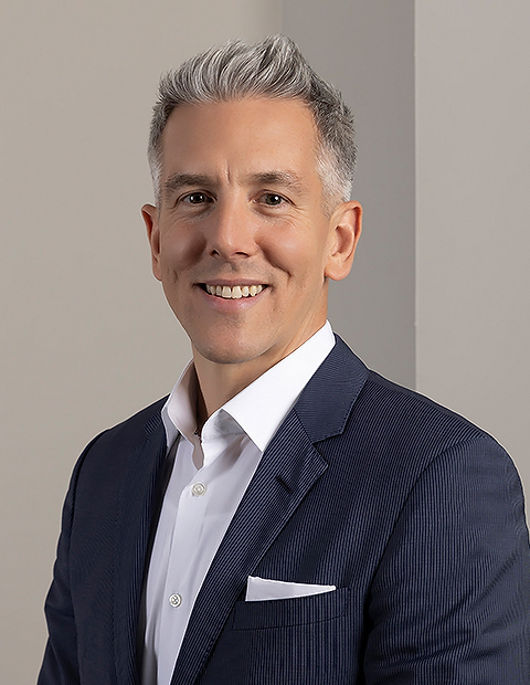 a man in a suit image of Tom Roman