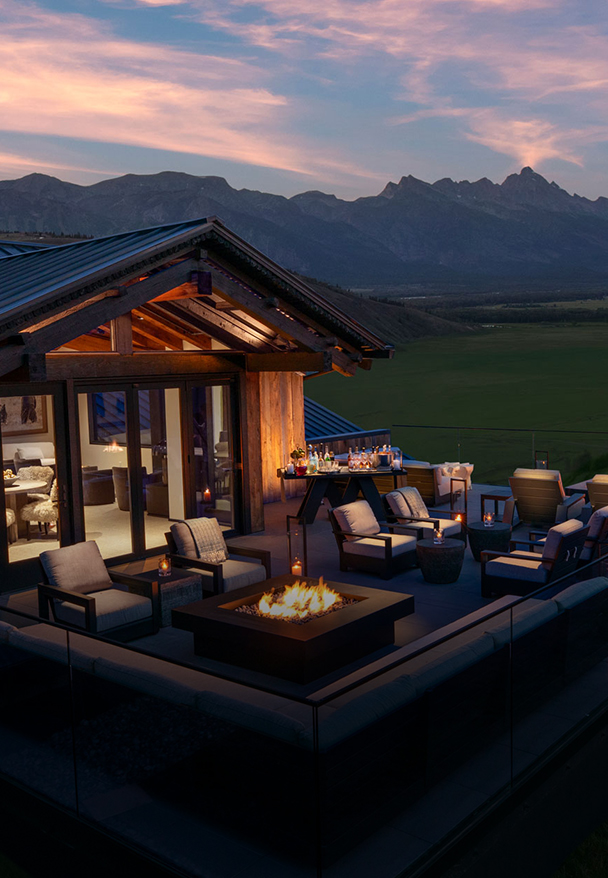 a house with a fire pit and chairs