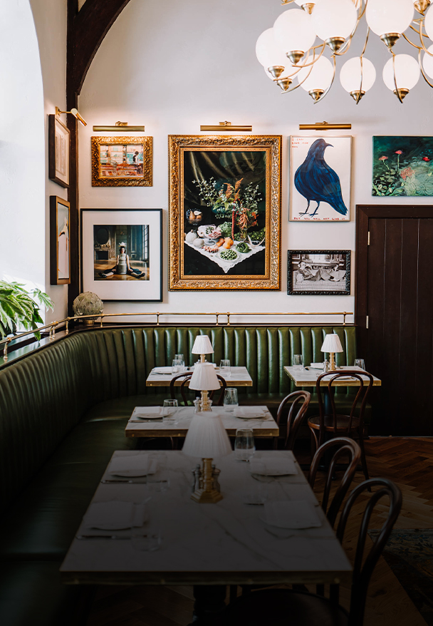 a booth with a table and chairs and art on the wall