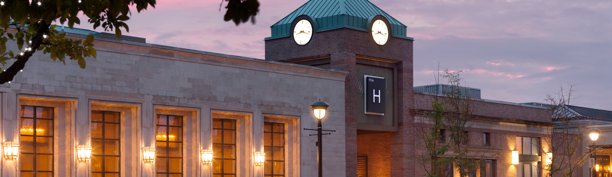 a clock tower with lights on top of a building