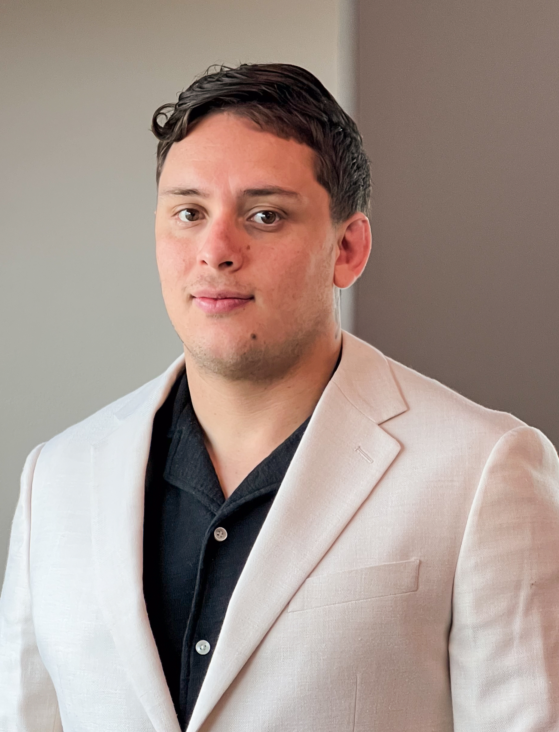 a man in a white suit image of TomasChavarria