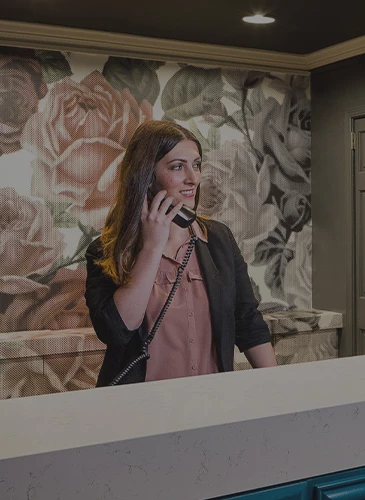 woman attending the phone in the reception 