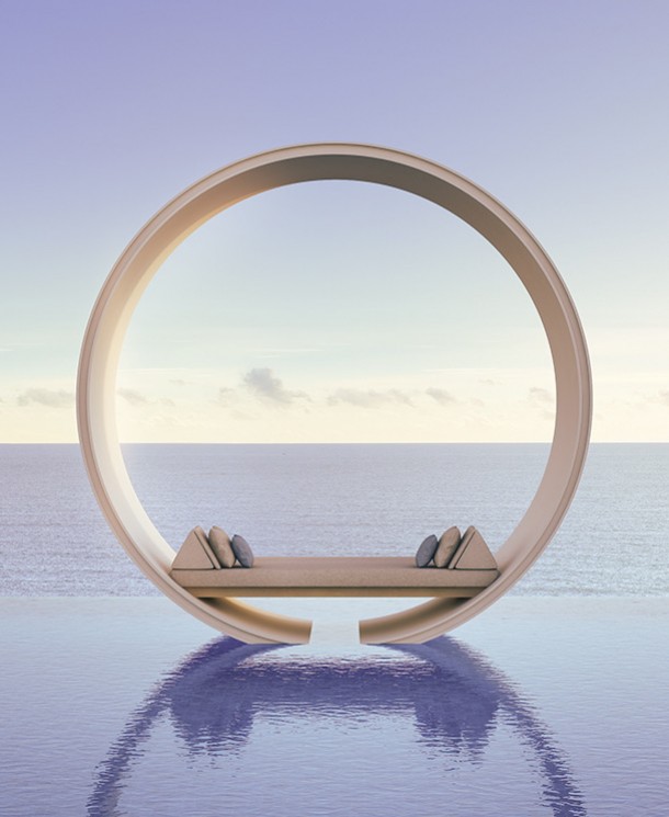 a round chair with pillows on the pool