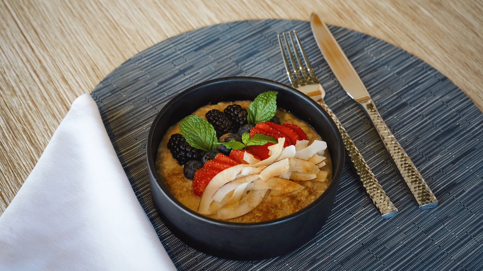 a bowl of food with fruit and leaves on top
