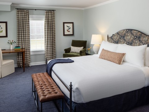 a bedroom with a bed and a chair