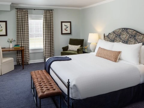 a bedroom with a bed and a chair