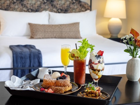 a tray of food on a bed
