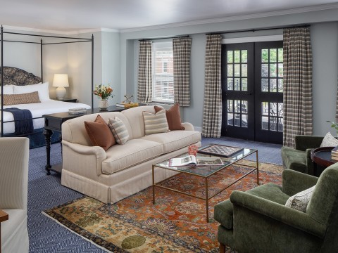 a room with a bed and couches