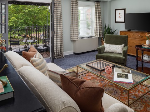 a living room with a glass table and couches