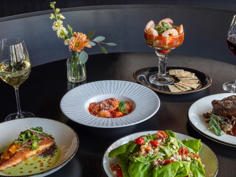 a table with plates of food and drinks