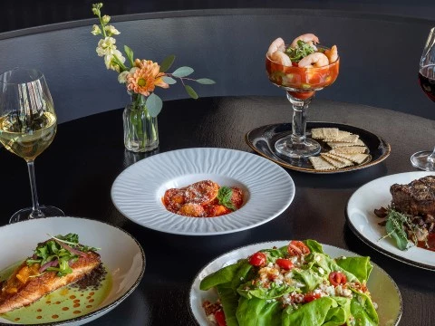a table with plates of food and drinks
