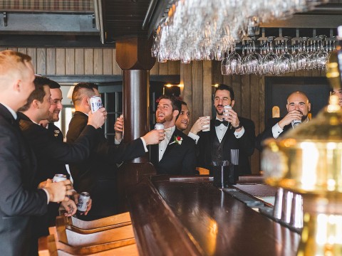 a group of men in suits drinking at a bar