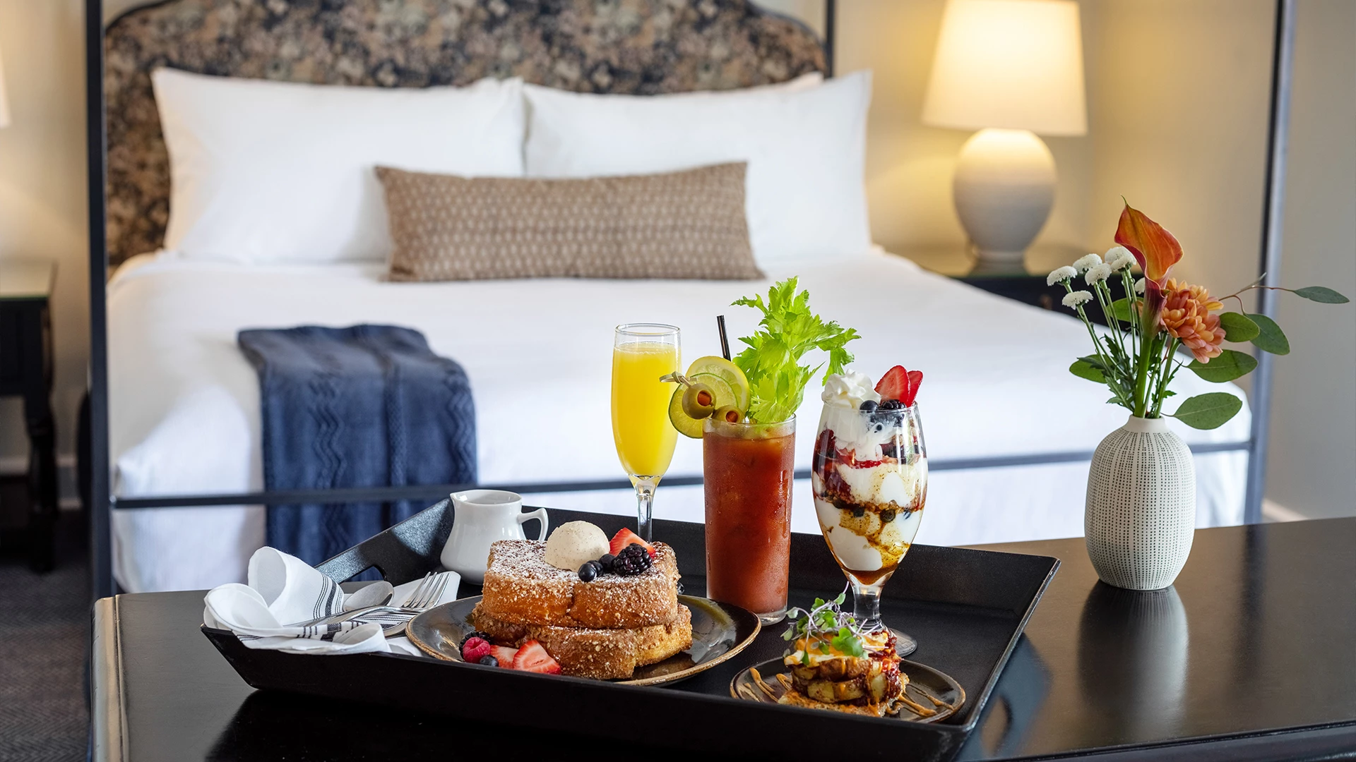 a tray of food on a bed