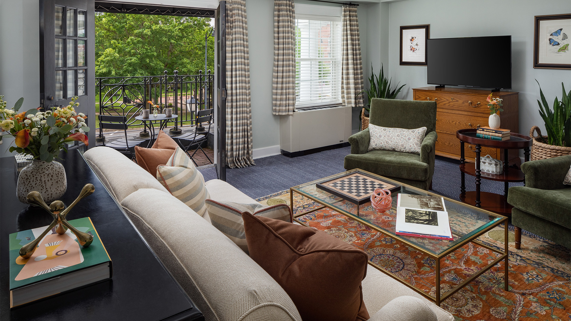 a living room with a glass table and couches