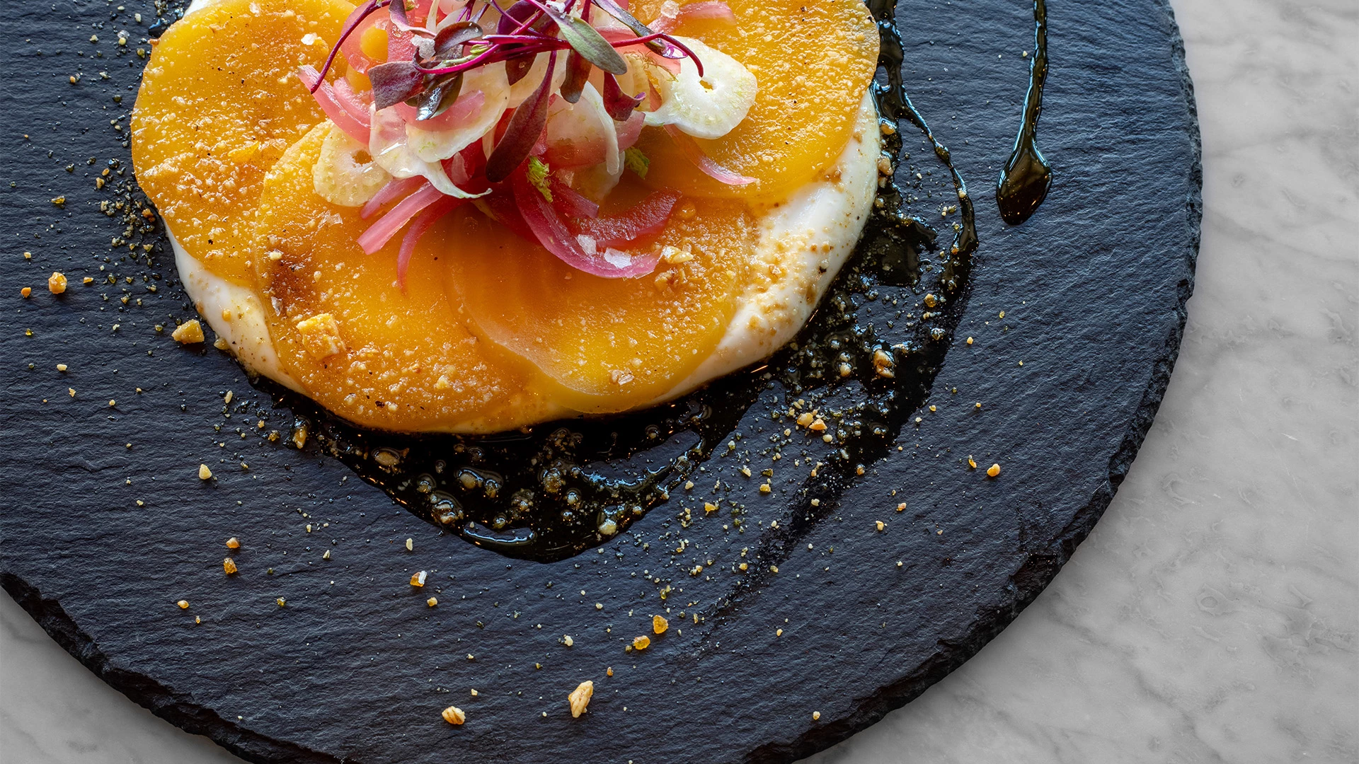 a plate of food with orange slices and vegetables