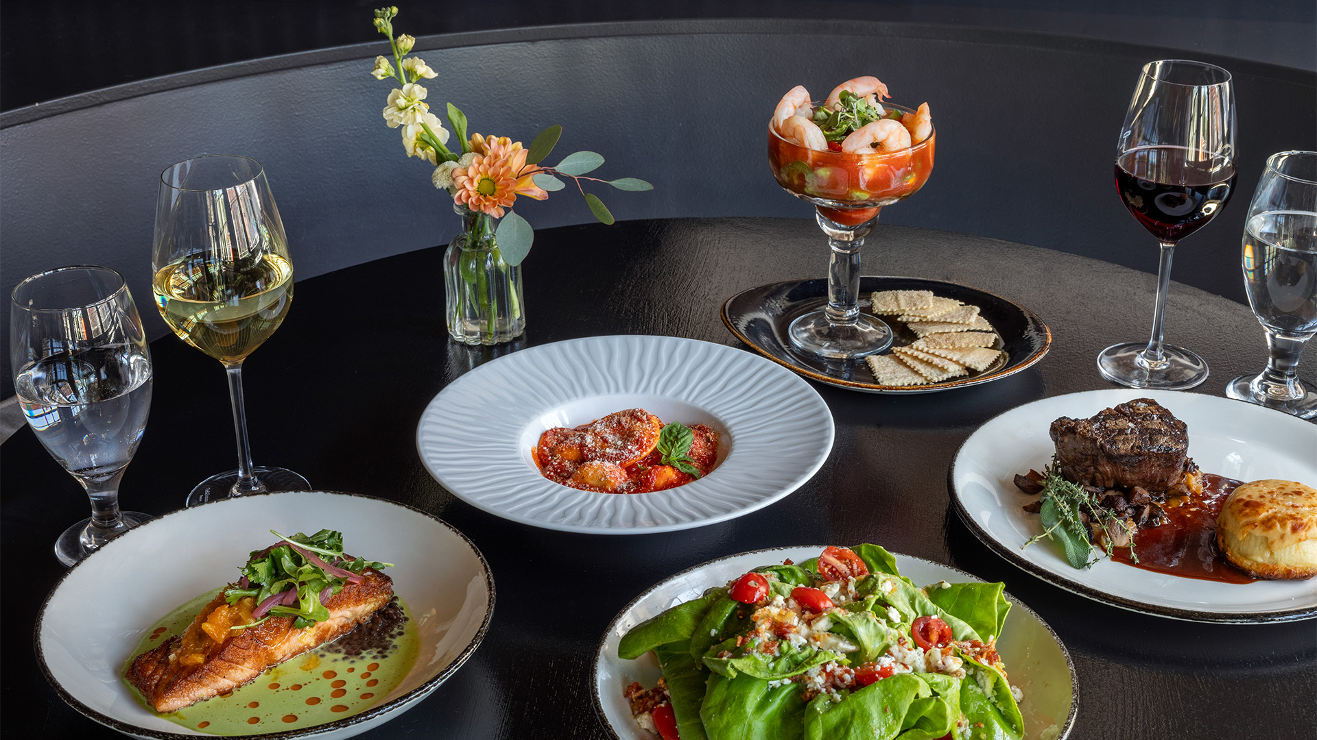 a table with plates of food and drinks