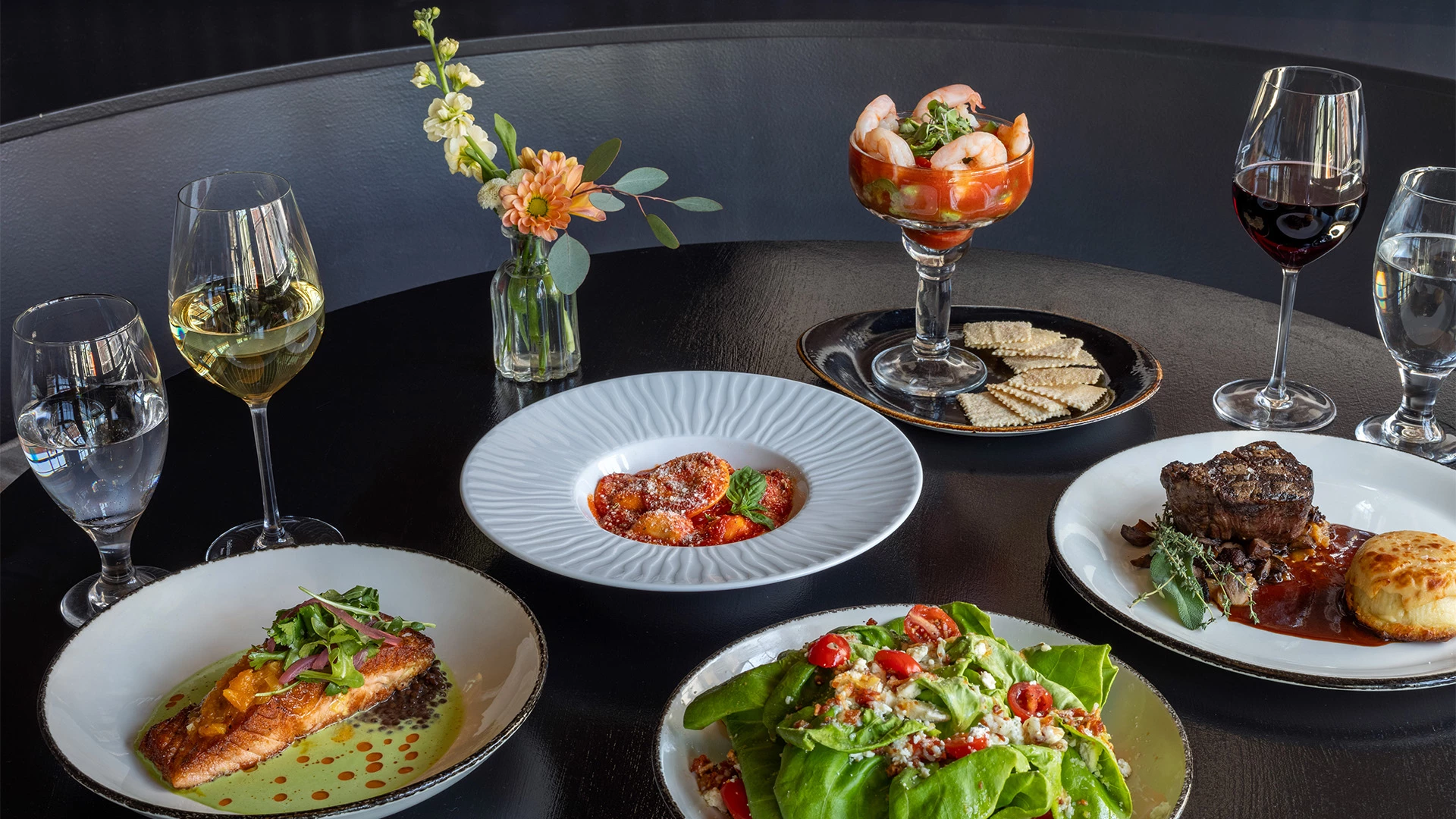a table with plates of food and drinks