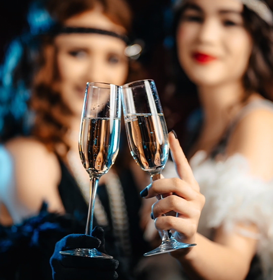 two women holding champagne glasses