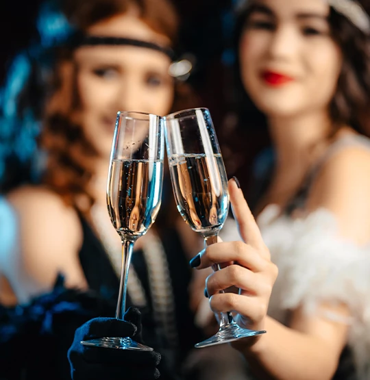 two women holding champagne glasses