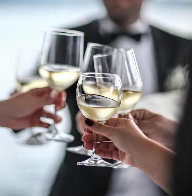 a group of people holding wine glasses