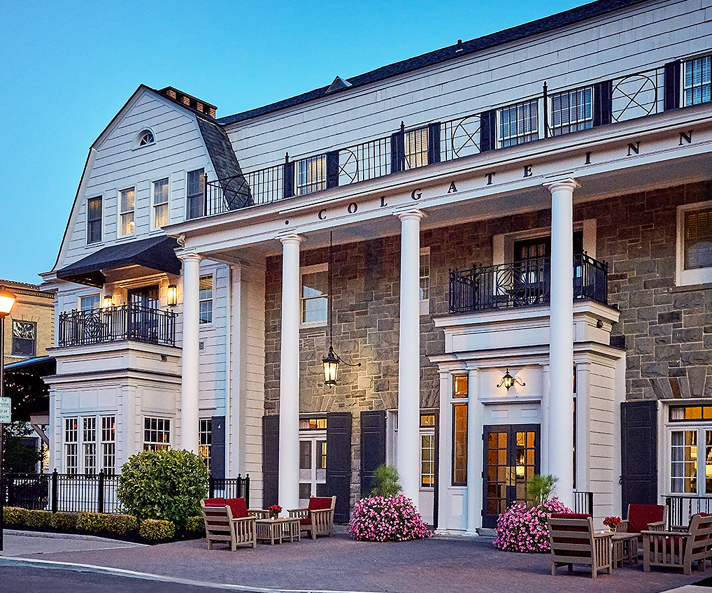 a building with columns and a stone wall