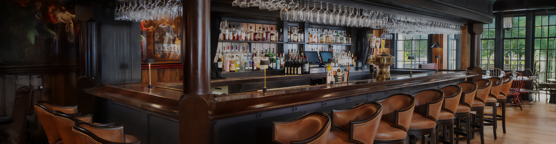 a bar with wine glasses from the ceiling