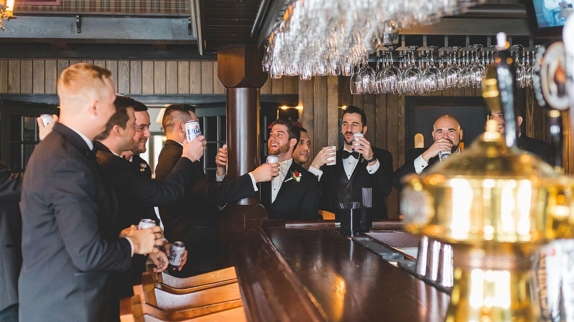a group of men in suits drinking at a bar