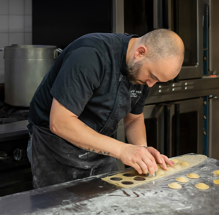 a man making ravioli in a kitchen