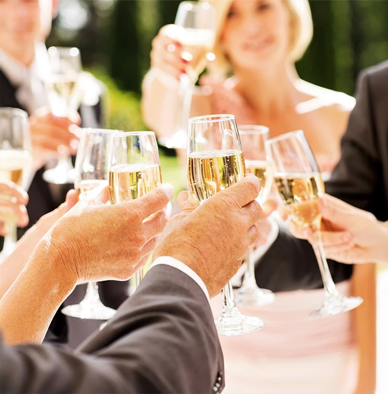 a group of people holding glasses of champagne