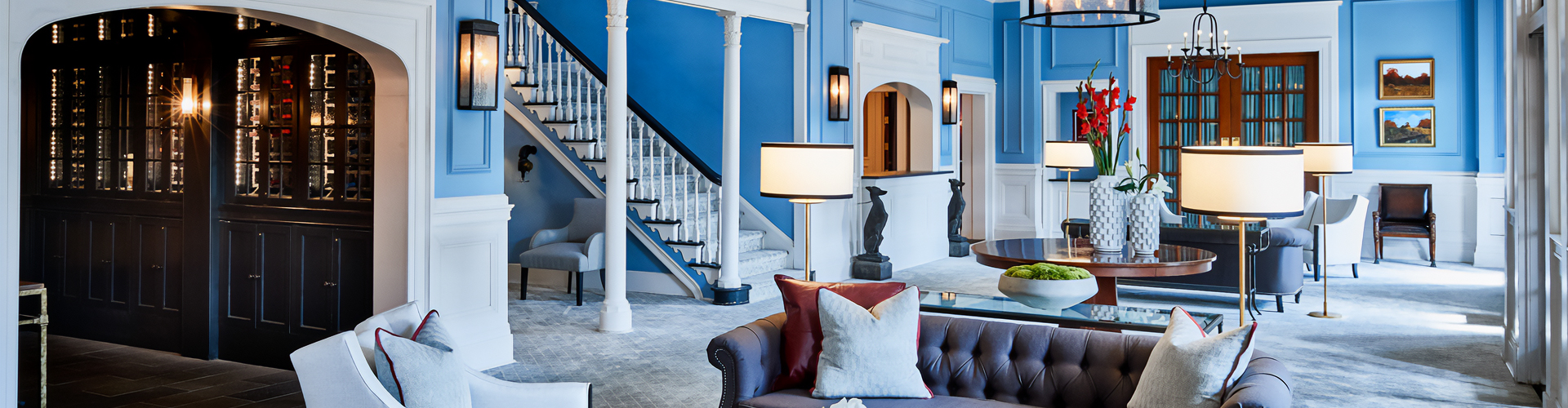 a blue room with a couch and a lamp