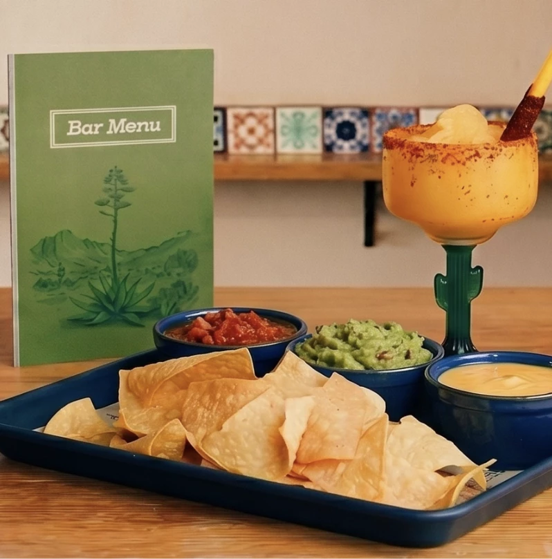 a bar menu with a plate of chips and dips