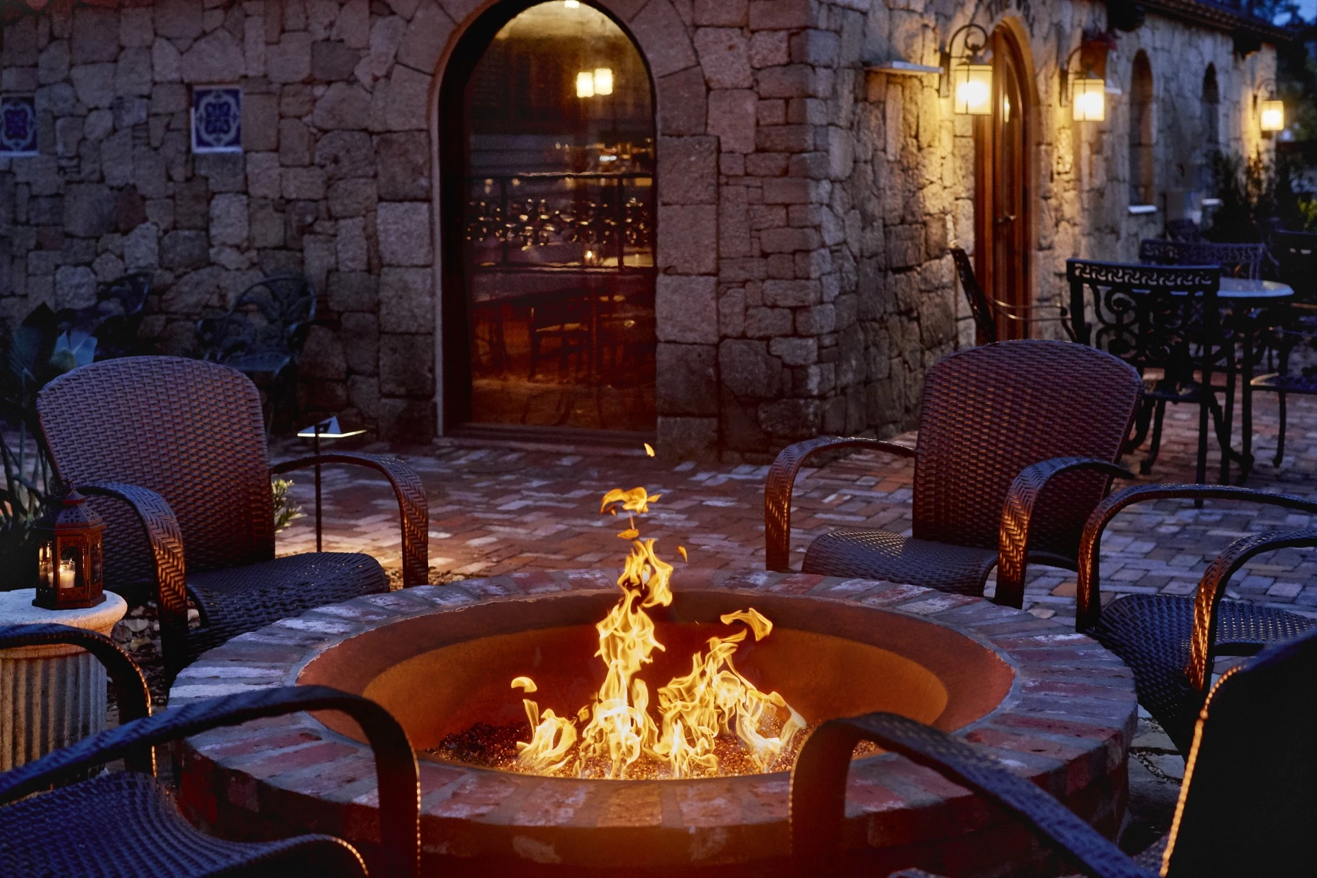 a fire pit with chairs around it