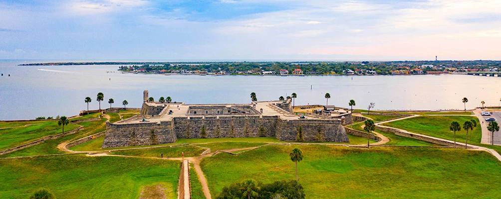 a castle on a hill overlooking a body of water