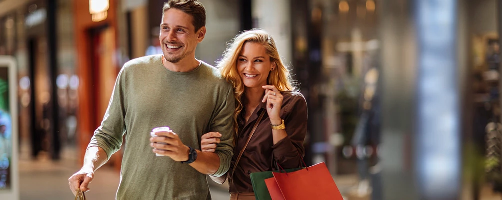 a man and a woman holding shopping bags