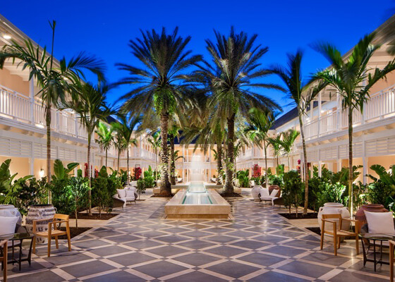 Clubhouse outdoor dining area with palm trees & water fountain