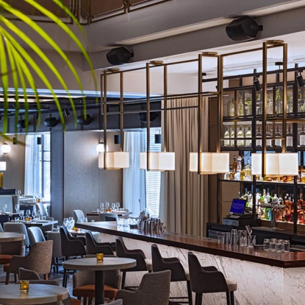 Lounge area with chairs, tables and bar