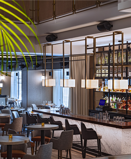 Lounge area with chairs, tables and bar