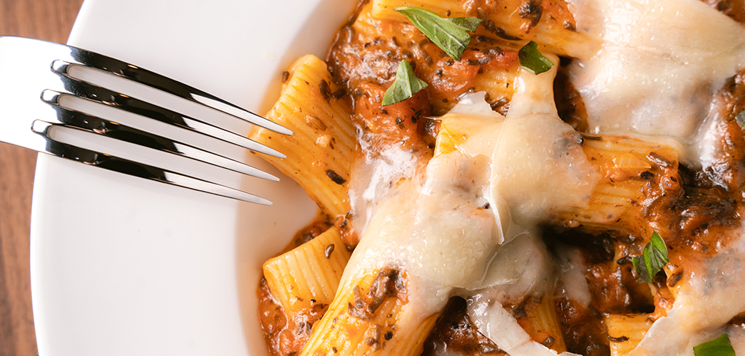 a fork in a bowl of pasta