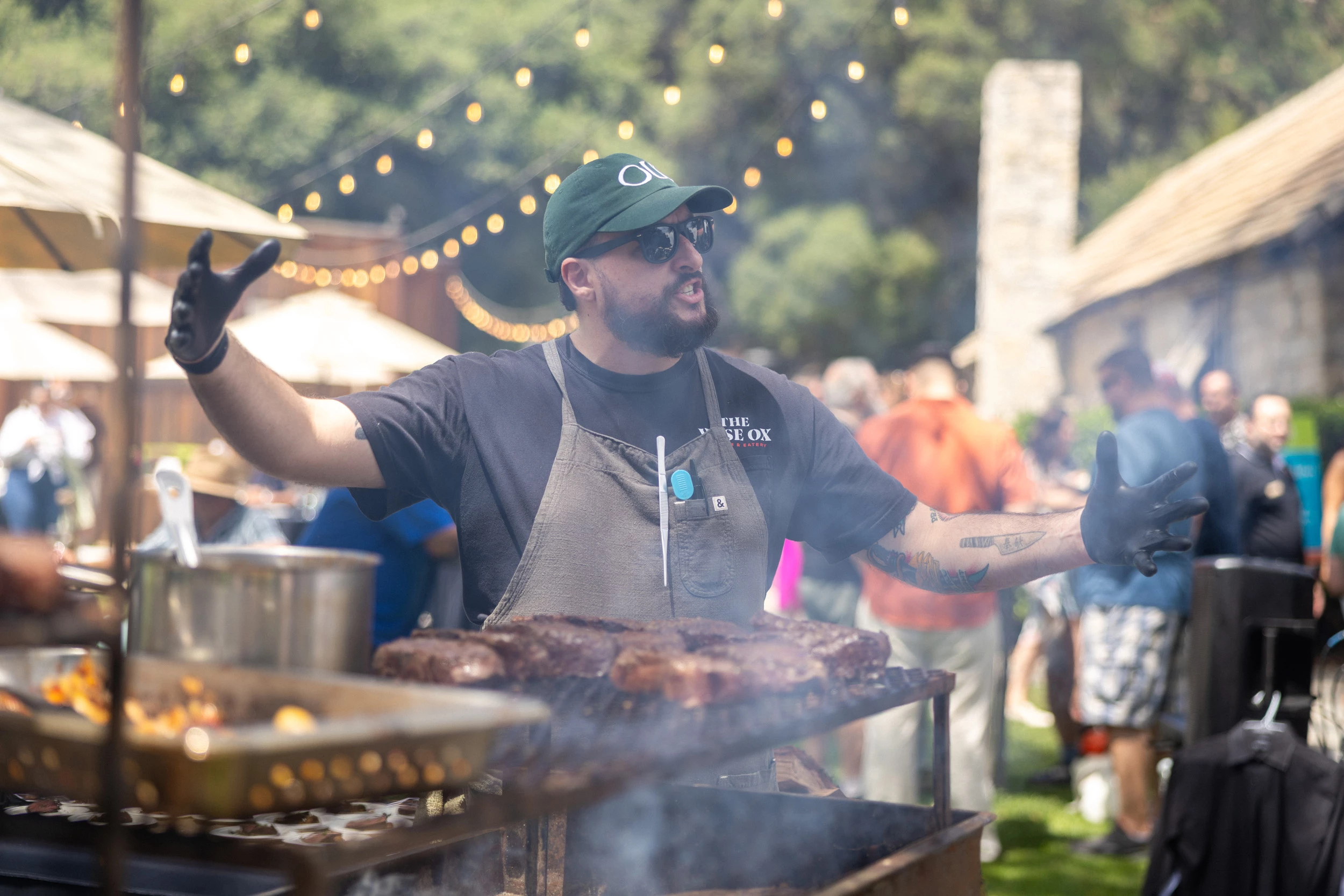 a man cooking meat on a grill