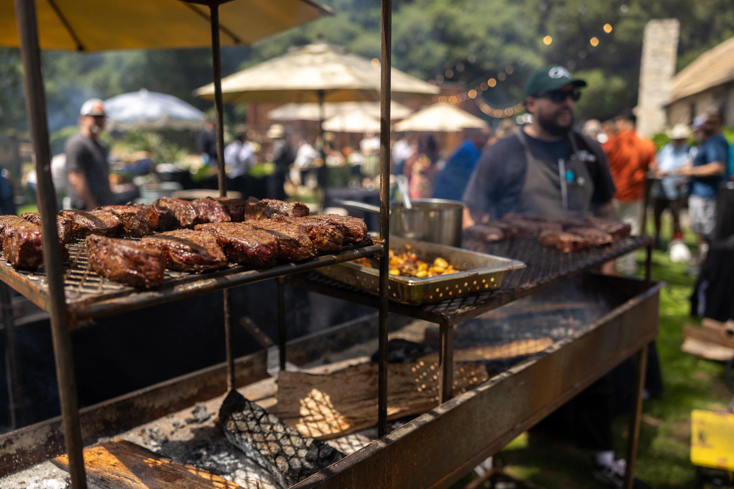 a man cooking meat on a grill